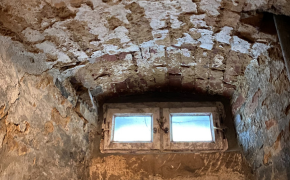 Im Altbau-Keller blättert der Putz von der feuchten Fensterlaibung